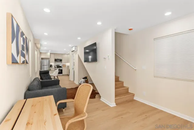 a living room with furniture and stairs