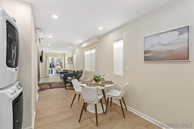 a view of a dining room with furniture and a chandelier