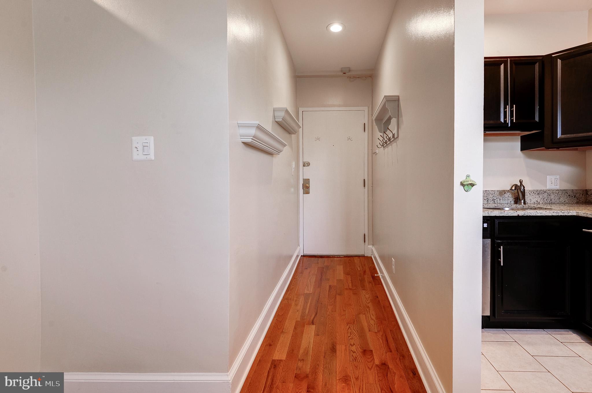637 3rd Street Northeast, Unit 305 Washington, DC 20002 - Photo 3 of 16 Inviting hallway with warm wood floors.