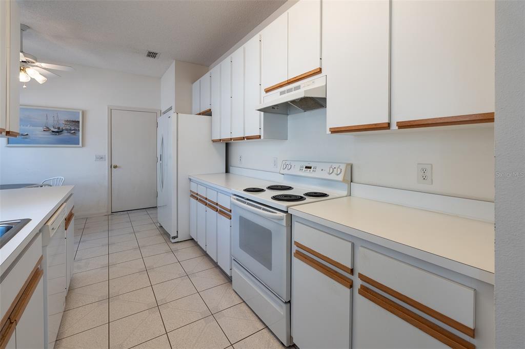 9077 Southwest 95th Terrace Ocala, FL 34481 - Photo 11 of 45 a kitchen with granite countertop a sink a stove and cabinets