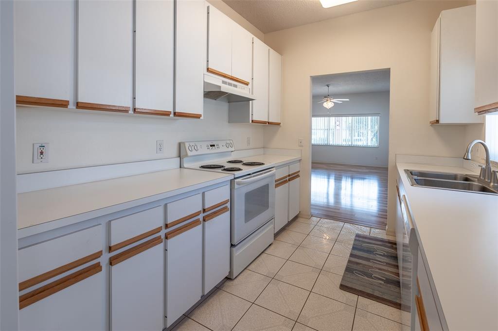 9077 Southwest 95th Terrace Ocala, FL 34481 - Photo 12 of 45 a kitchen with granite countertop white cabinets and white appliances