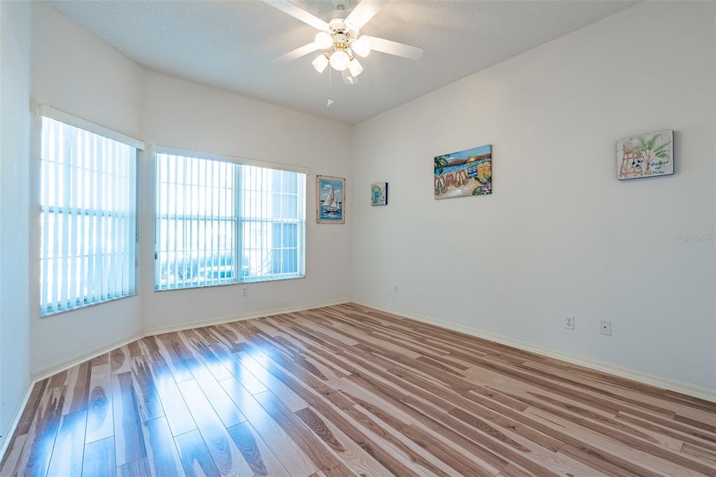 9077 Southwest 95th Terrace Ocala, FL 34481 - Photo 24 of 45 a view of an empty room with wooden floor and a window