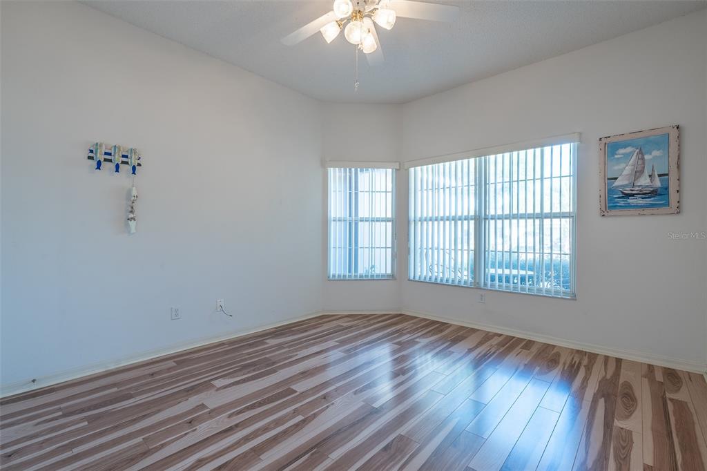 9077 Southwest 95th Terrace Ocala, FL 34481 - Photo 25 of 45 a view of an empty room with wooden floor and a window