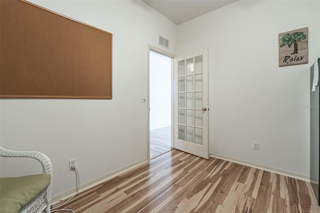 9077 Southwest 95th Terrace Ocala, FL 34481 - Photo 32 of 45 a view of empty room with wooden floor