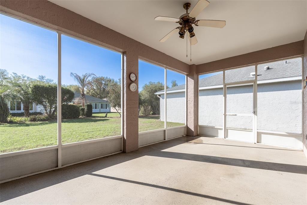 9077 Southwest 95th Terrace Ocala, FL 34481 - Photo 33 of 45 a bedroom with a large bed and a chandelier fan