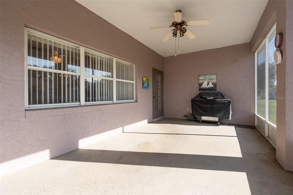 9077 Southwest 95th Terrace Ocala, FL 34481 - Photo 35 of 45 a bedroom with a bed and a chandelier
