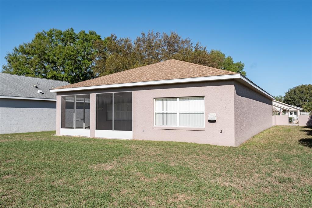 9077 Southwest 95th Terrace Ocala, FL 34481 - Photo 39 of 45 a view of a house with a yard