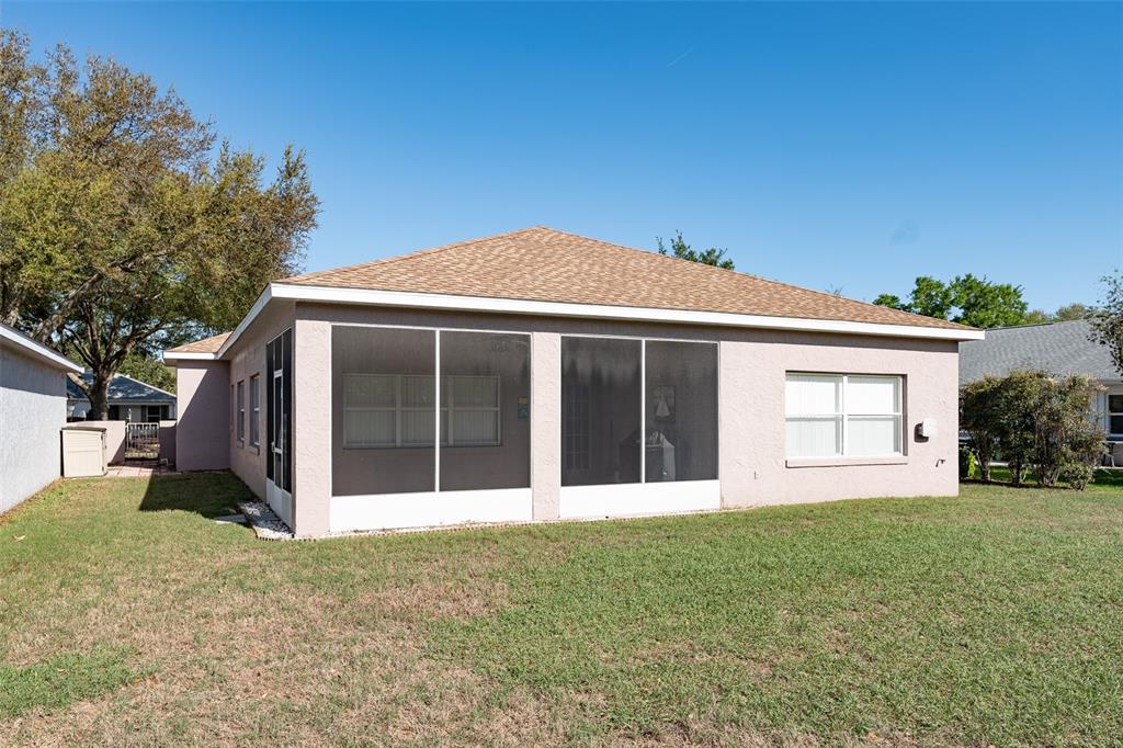 9077 Southwest 95th Terrace Ocala, FL 34481 - Photo 40 of 45 a front view of a house with a garden