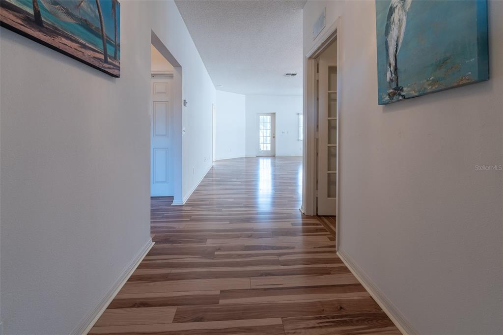 9077 Southwest 95th Terrace Ocala, FL 34481 - Photo 4 of 45 a view of a hallway with wooden floor and staircase