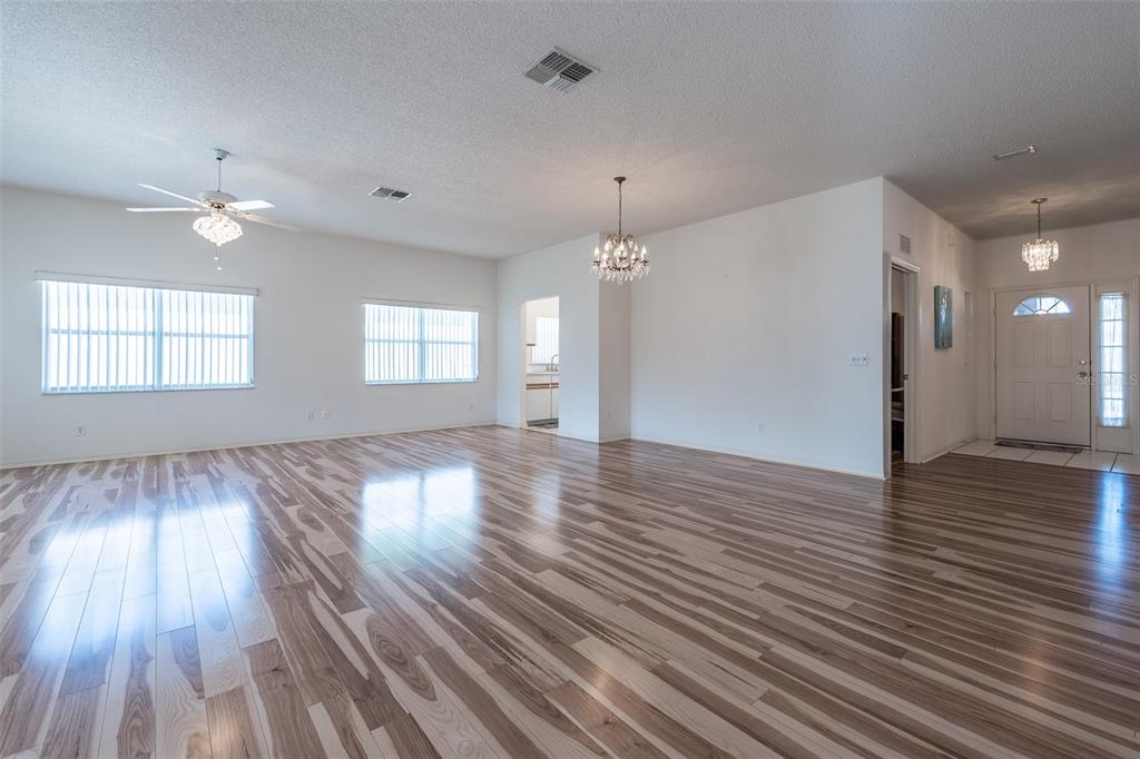 9077 Southwest 95th Terrace Ocala, FL 34481 - Photo 8 of 45 an empty room with wooden floor and windows