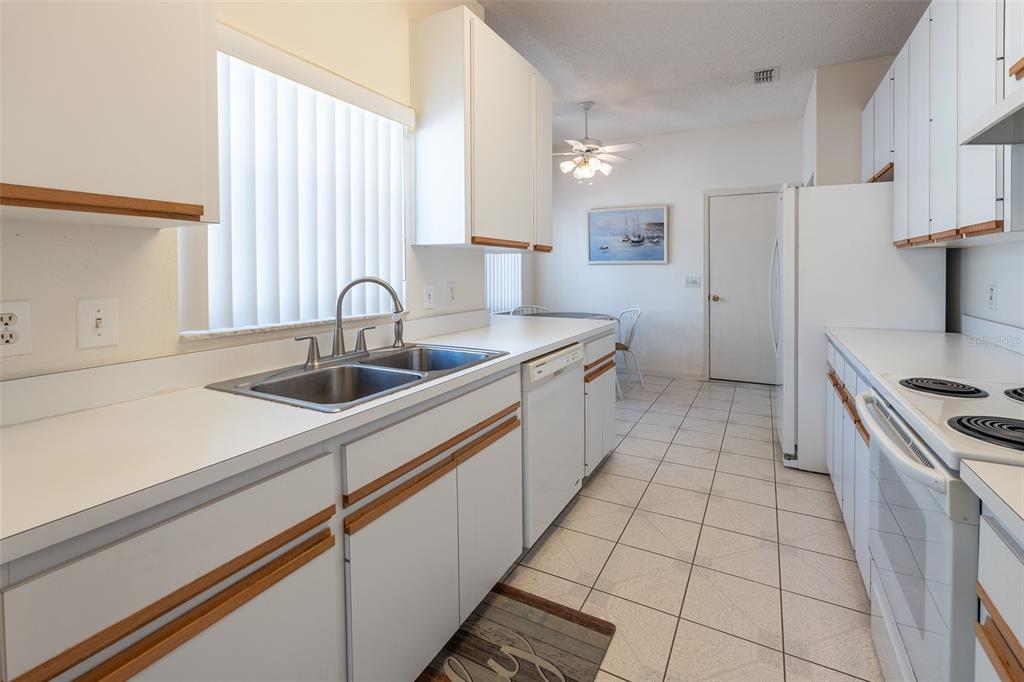 9077 Southwest 95th Terrace Ocala, FL 34481 - Photo 10 of 45 a kitchen with a sink and a stove top oven
