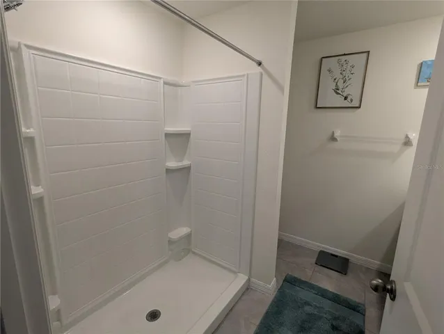 a bathroom with a shower and a sink