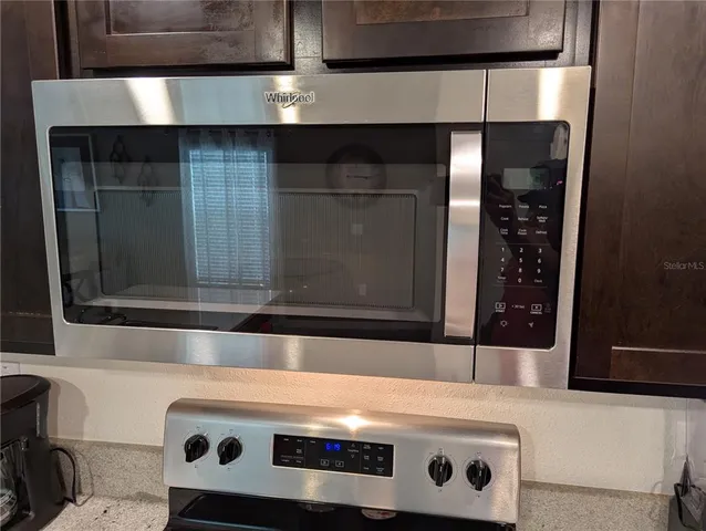 a stove top oven sitting inside of a kitchen