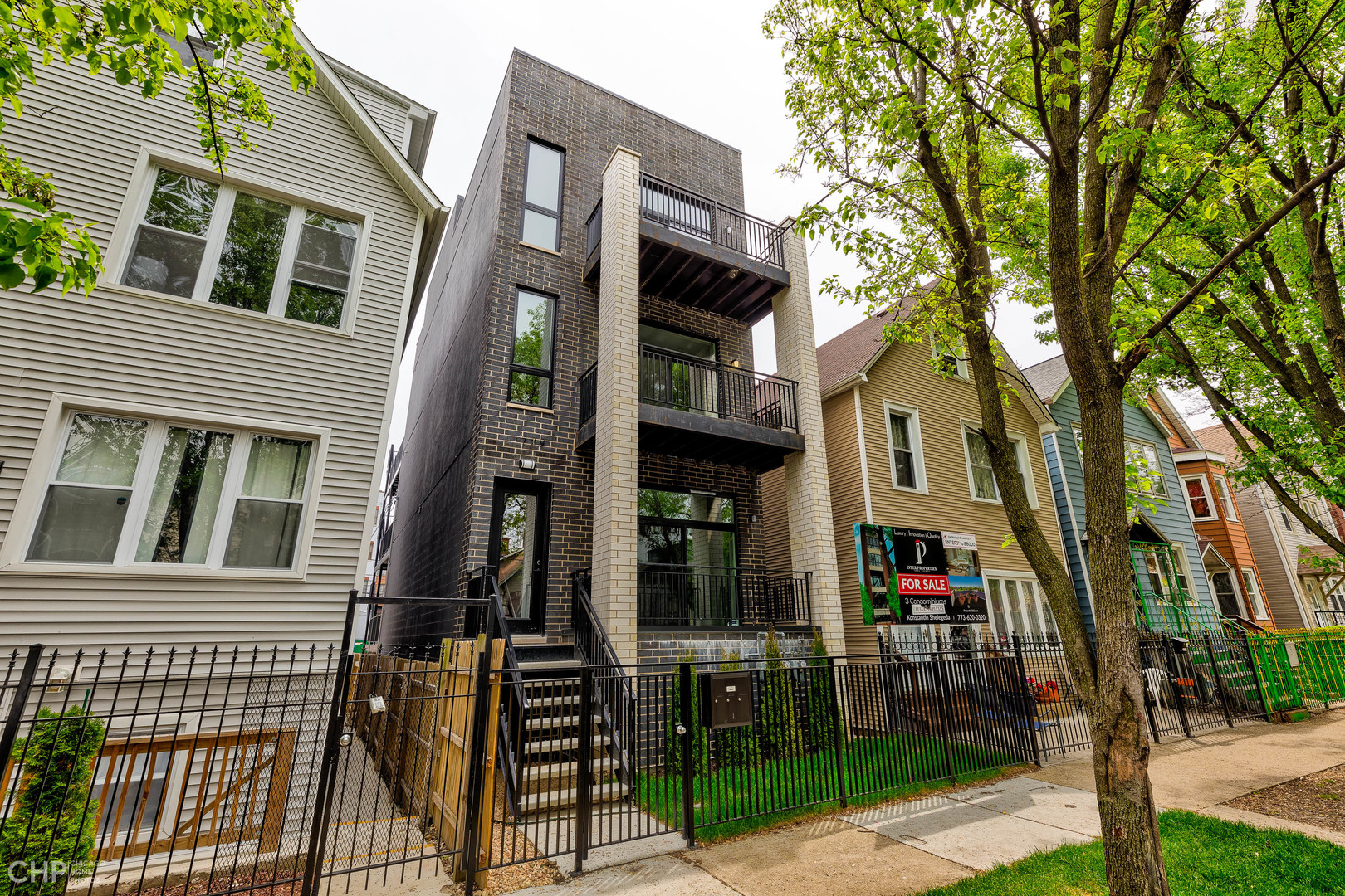 1729 North Artesian Avenue, Unit 1 Chicago, IL 60647 - Photo 1 of 17 a front view of a building with a garden