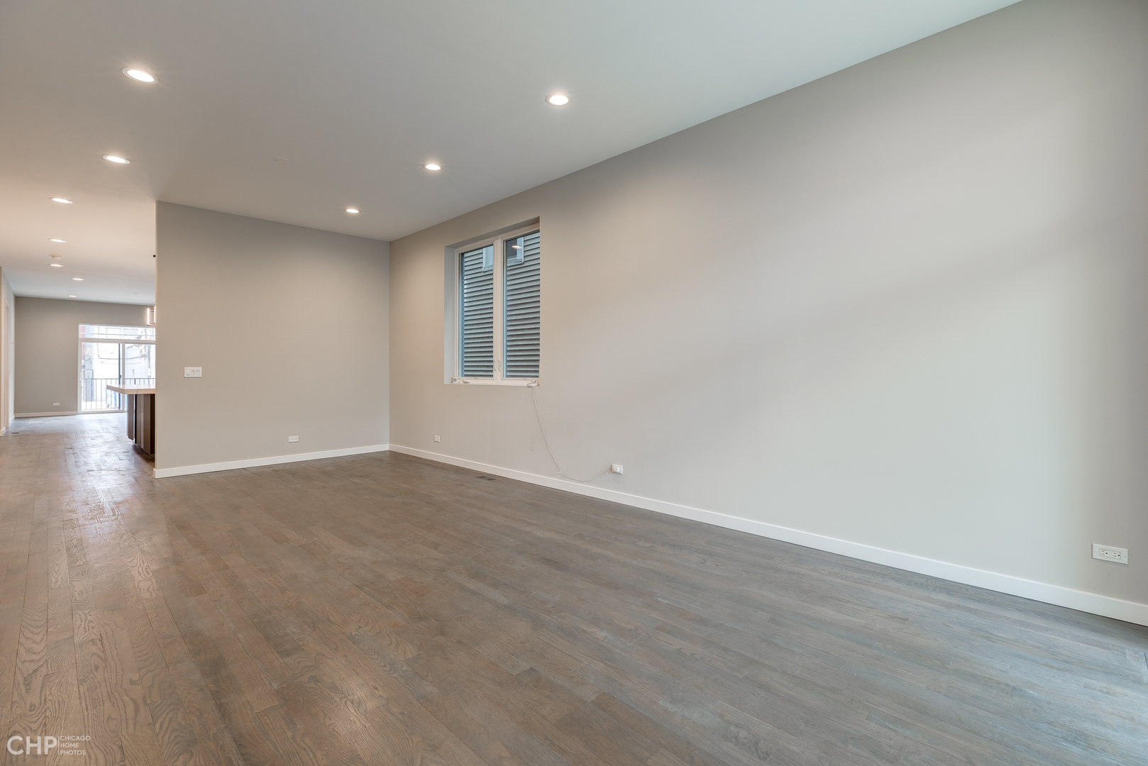 1729 North Artesian Avenue, Unit 1 Chicago, IL 60647 - Photo 4 of 17 an empty room with wooden floor and windows