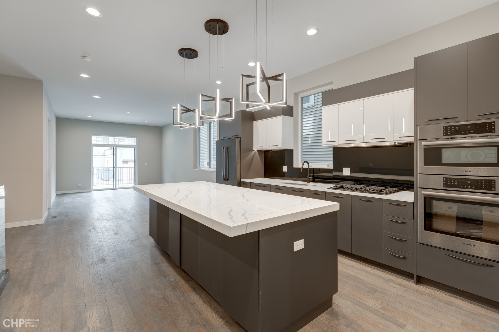 1729 North Artesian Avenue, Unit 1 Chicago, IL 60647 - Photo 6 of 17 a kitchen with stainless steel appliances kitchen island granite countertop a stove a sink and a refrigerator