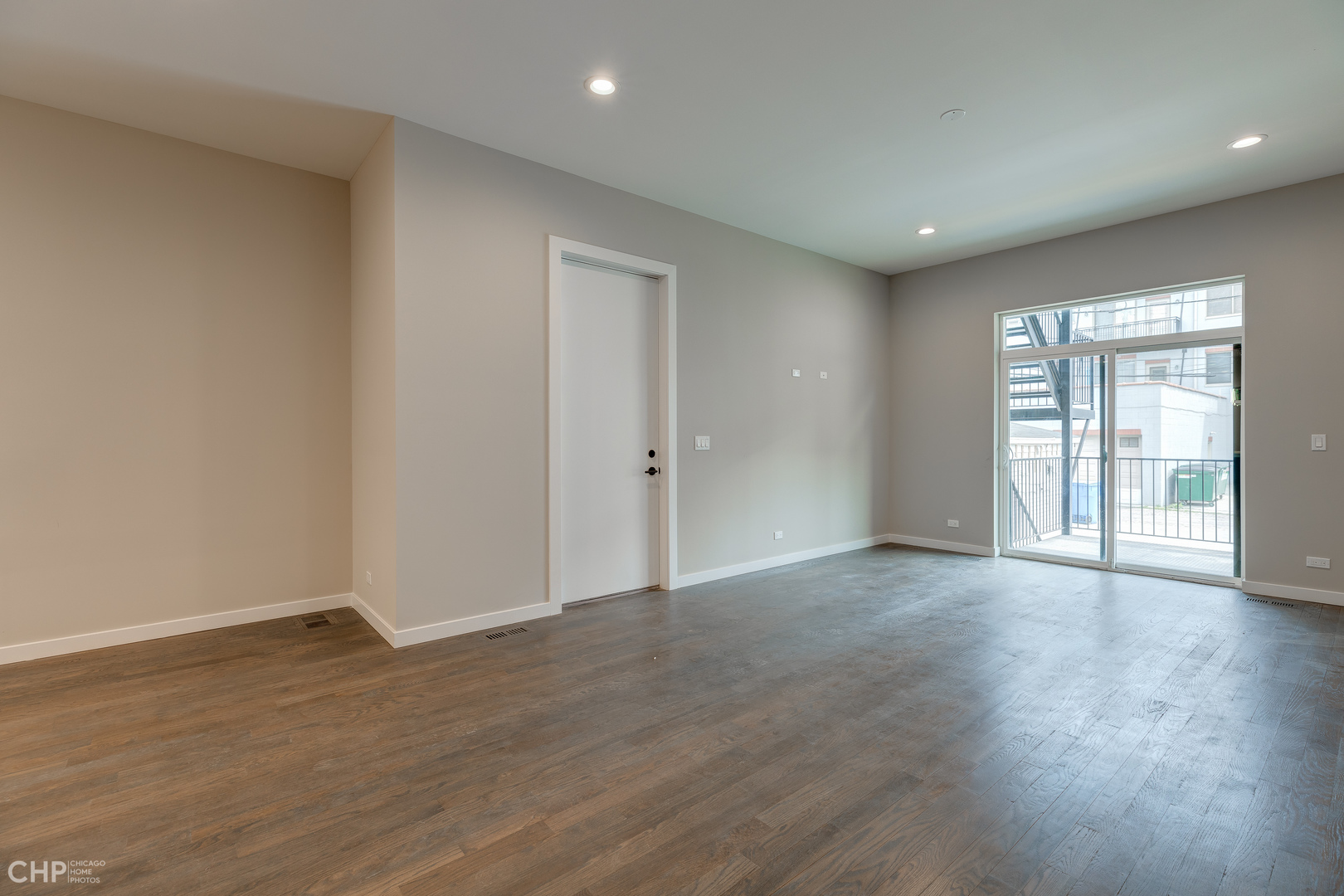 1729 North Artesian Avenue, Unit 1 Chicago, IL 60647 - Photo 8 of 17 a view of an empty room with wooden floor and a window