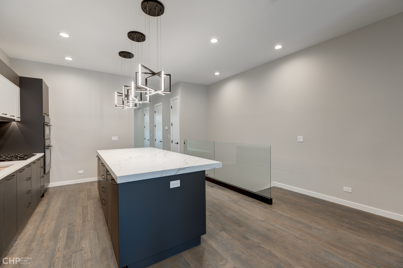 1729 North Artesian Avenue, Unit 1 Chicago, IL 60647 - Photo 10 of 17 a kitchen with stainless steel appliances a chandelier and wooden floor