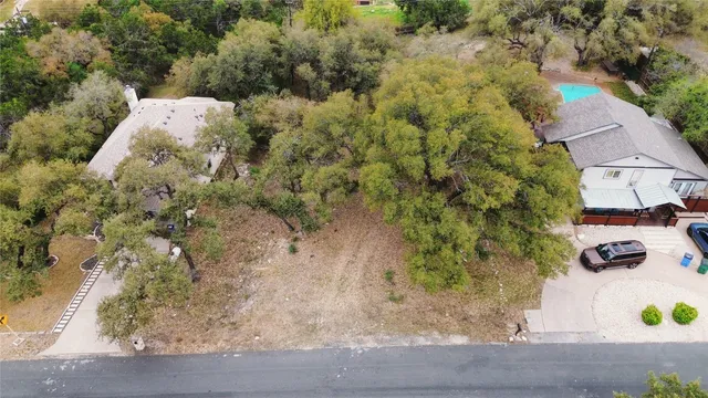 an aerial view of a houses with yard