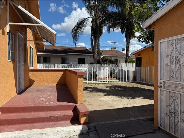 a backyard of a house with table and chairs