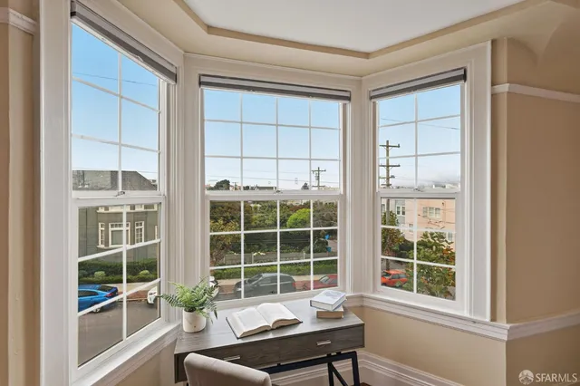a balcony with wooden floor and a potted plant