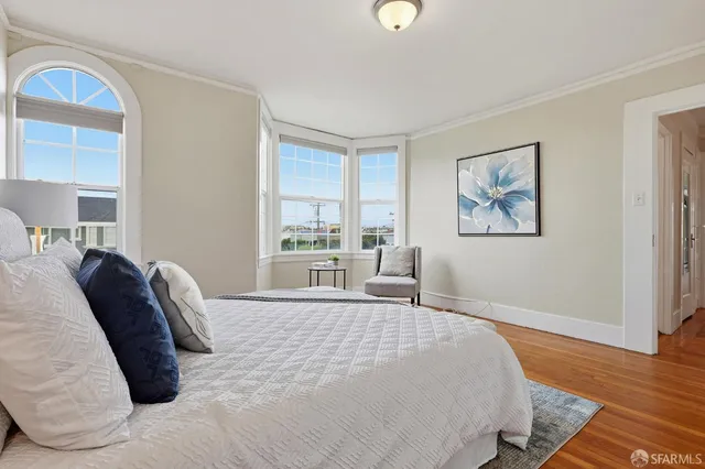 a bedroom with a large bed and a window