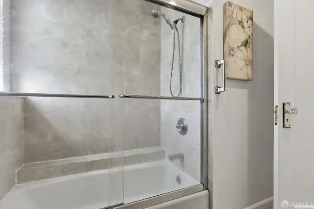a bathroom with a shower and a bath tub