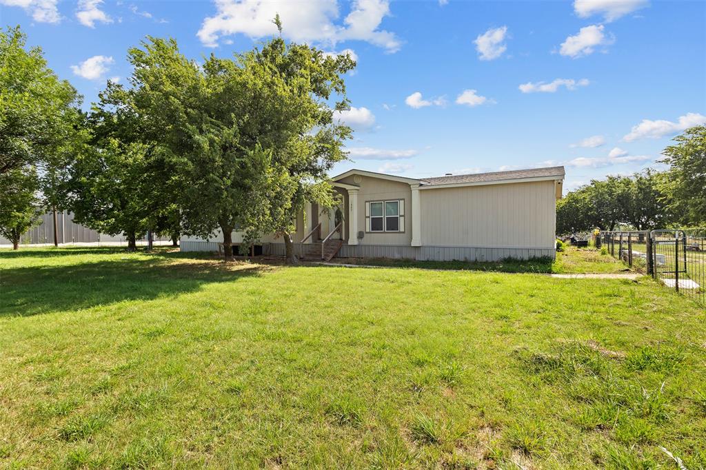 a front view of house with yard and trees