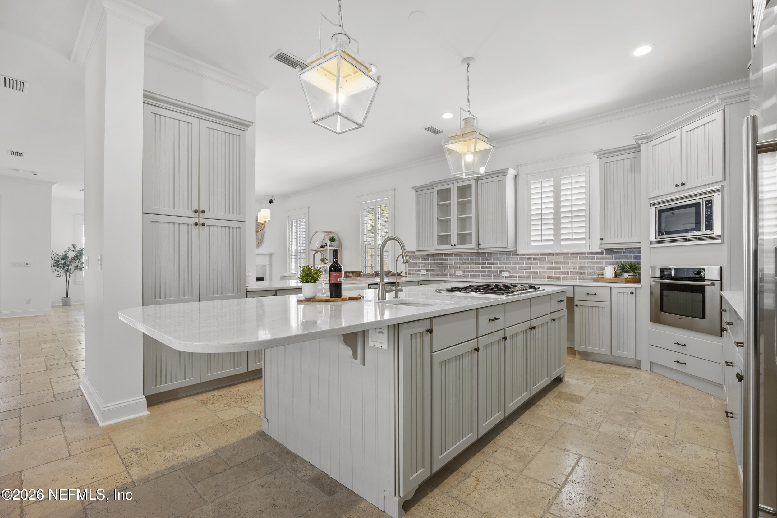2912 Abaco Lane Jacksonville Beach, FL 32250 - Photo 14 of 46 a large kitchen with kitchen island white cabinets and stainless steel appliances
