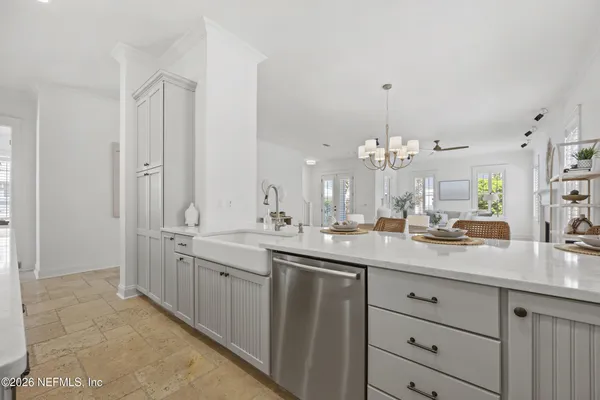 a view of a double sink and chandelier
