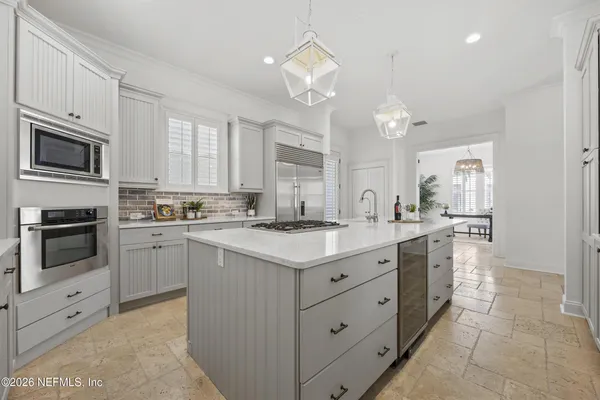 a kitchen with a sink stove and microwave