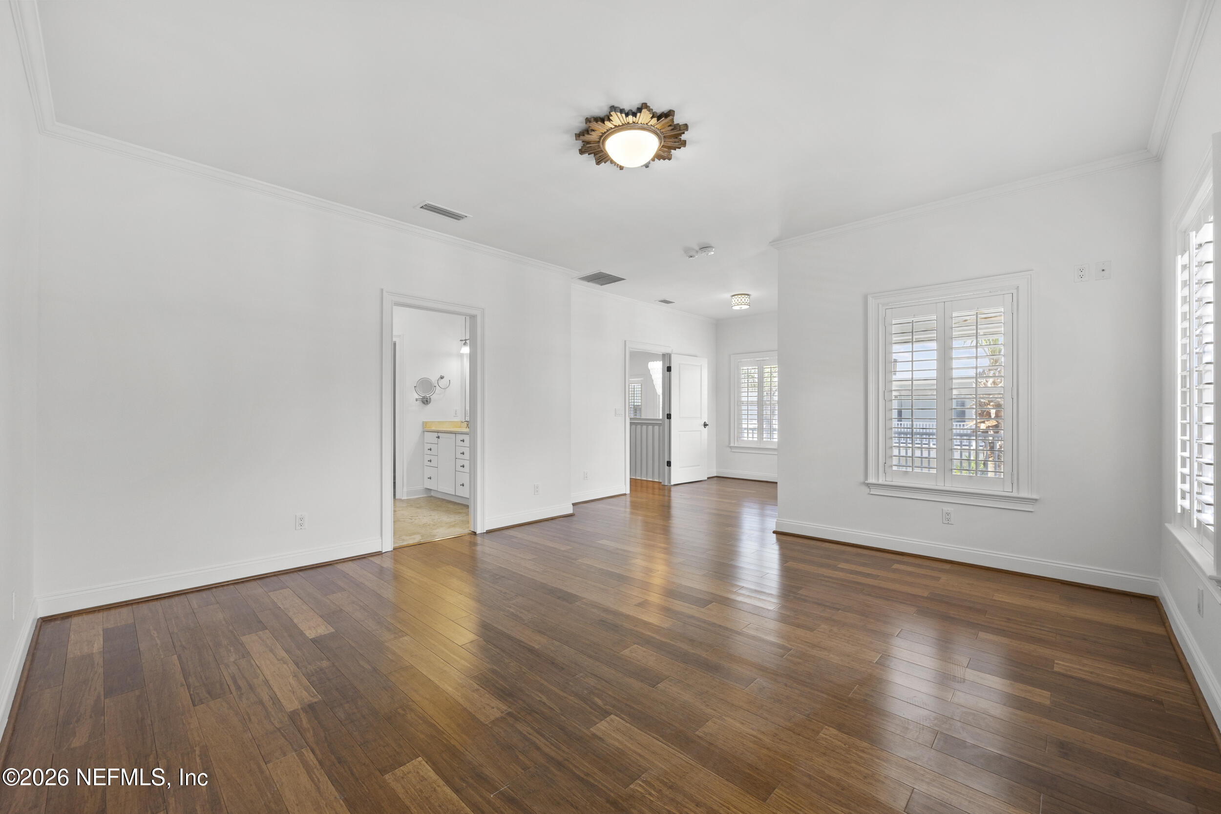 2912 Abaco Lane Jacksonville Beach, FL 32250 - Photo 25 of 46 a view of an empty room with wooden floor and a window