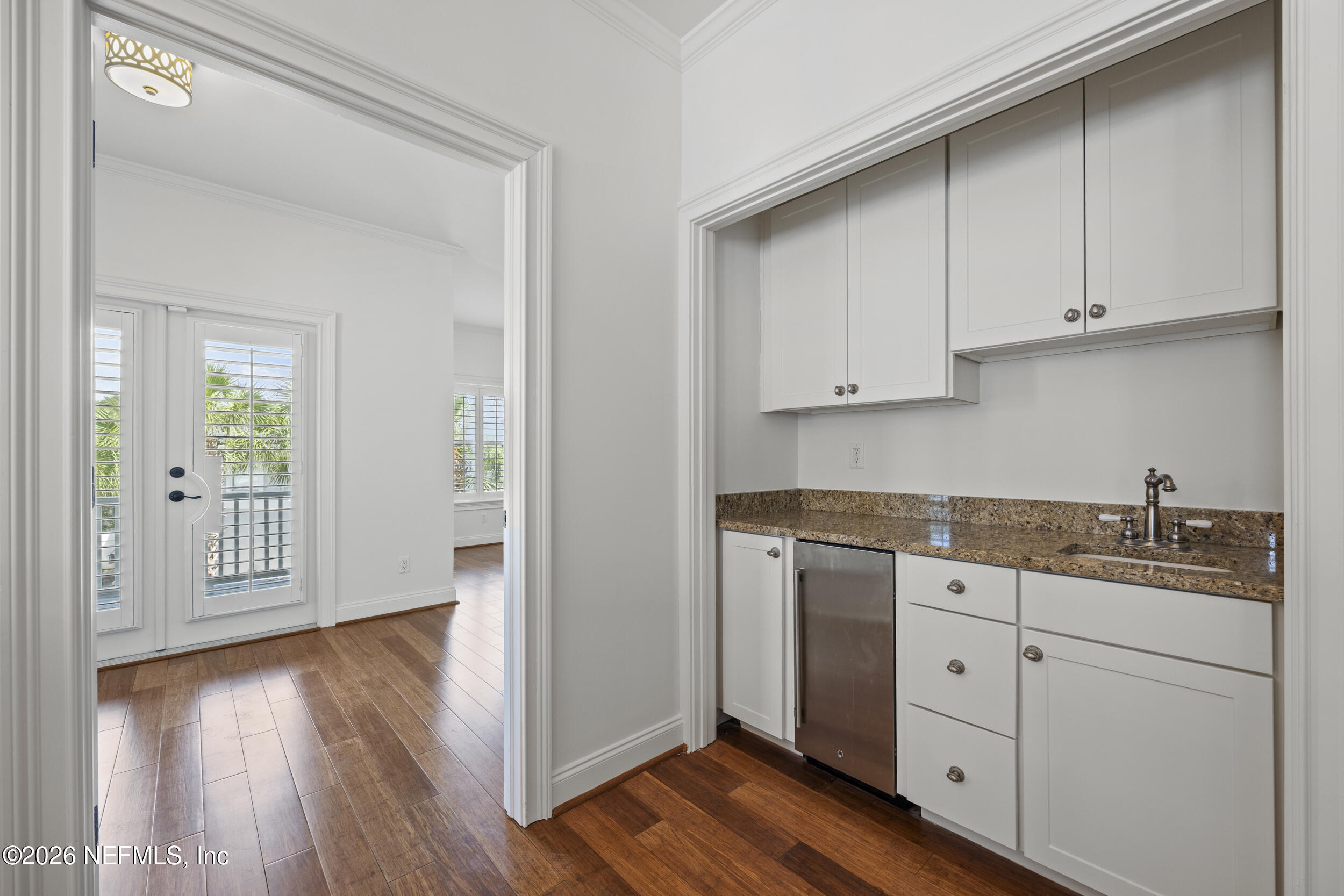 2912 Abaco Lane Jacksonville Beach, FL 32250 - Photo 30 of 46 a kitchen with stainless steel appliances granite countertop a sink and cabinets with wooden floor