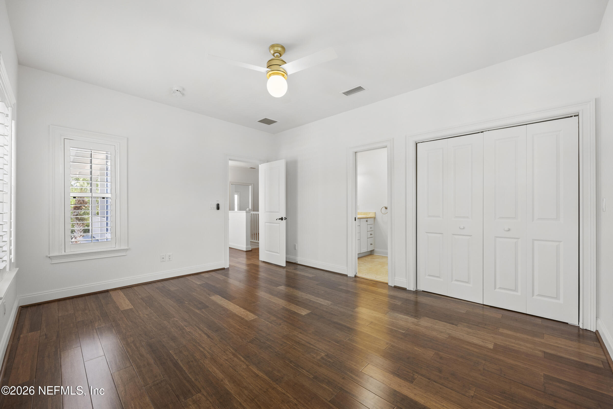2912 Abaco Lane Jacksonville Beach, FL 32250 - Photo 32 of 46 an empty room with wooden floor and window