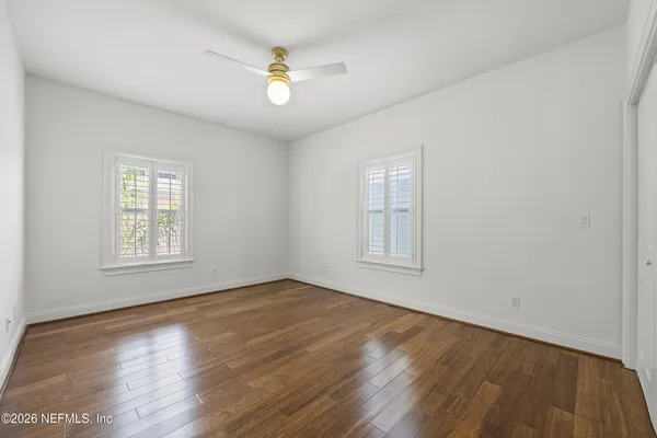 a view of an empty room with wooden floor