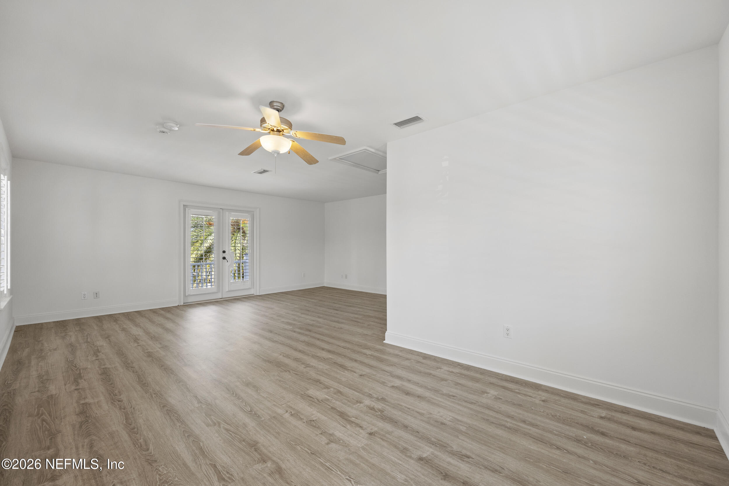 2912 Abaco Lane Jacksonville Beach, FL 32250 - Photo 39 of 46 a view of an empty room with window and wooden floor