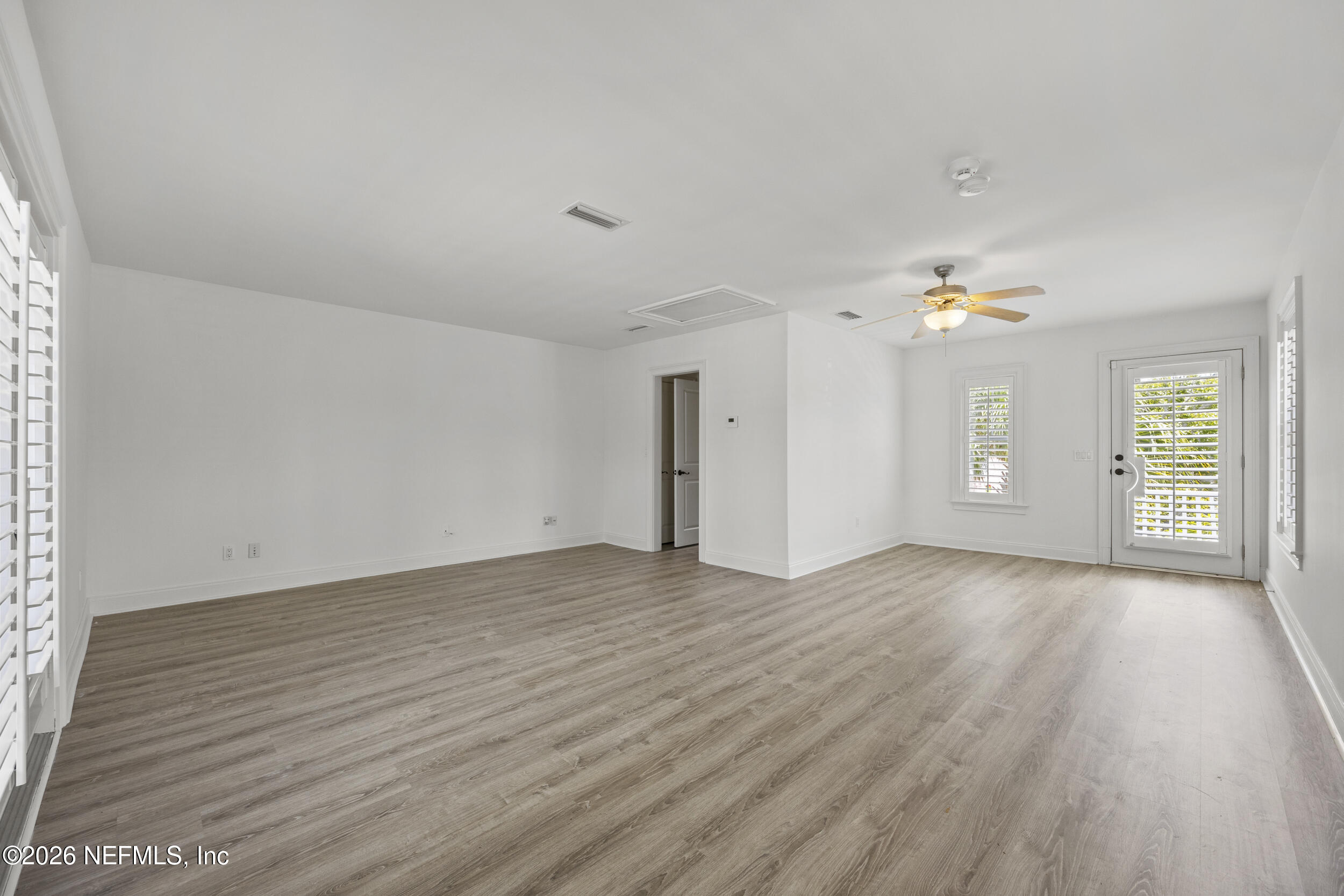 2912 Abaco Lane Jacksonville Beach, FL 32250 - Photo 40 of 46 an empty room with wooden floor and windows