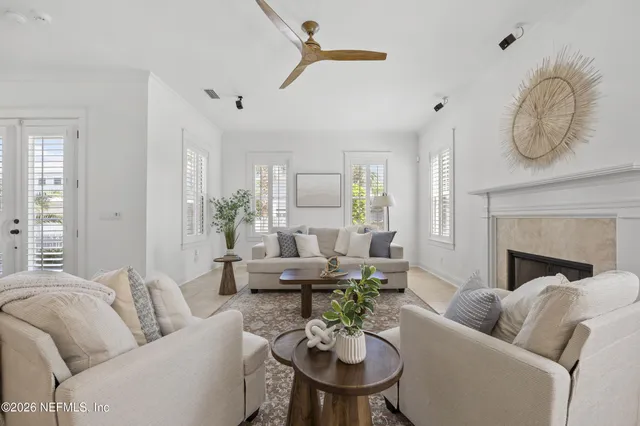 a living room with furniture fireplace and window