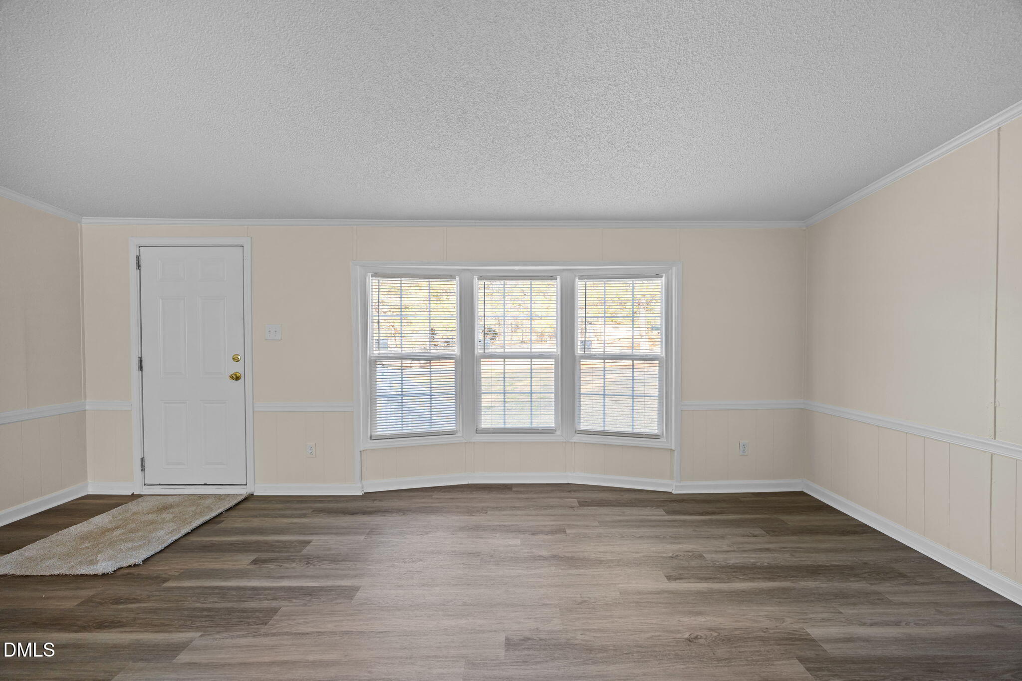 91 Pine Ridge Road Henderson, NC 27537 - Photo 11 of 50 a view of an empty room with wooden floor and a window