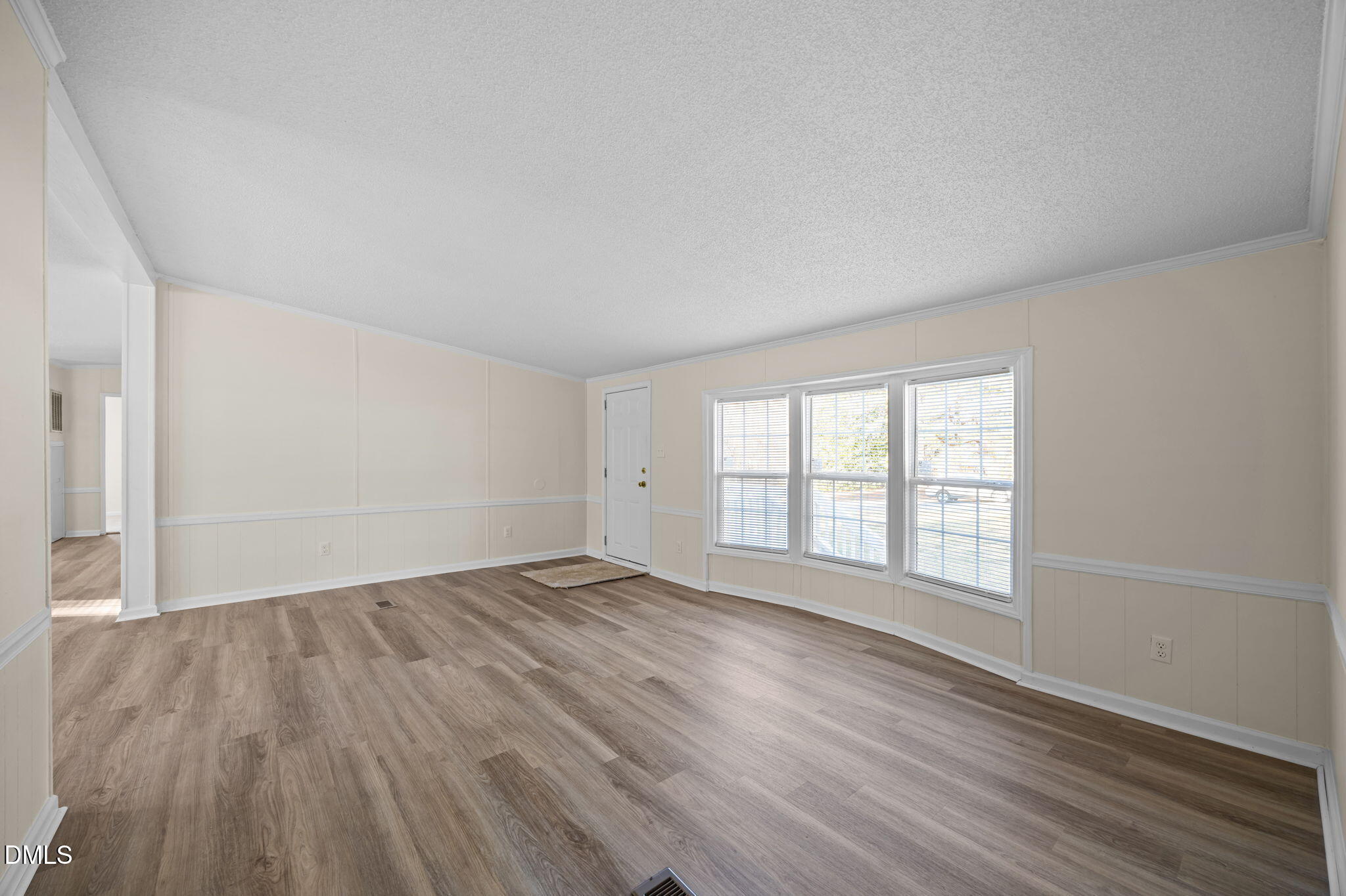 91 Pine Ridge Road Henderson, NC 27537 - Photo 12 of 50 an empty room with wooden floor and windows