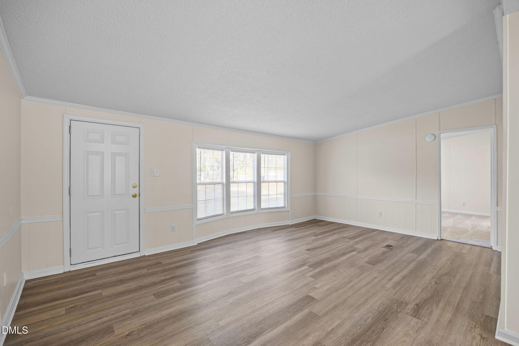 91 Pine Ridge Road Henderson, NC 27537 - Photo 13 of 50 a view of an empty room with wooden floor and a window