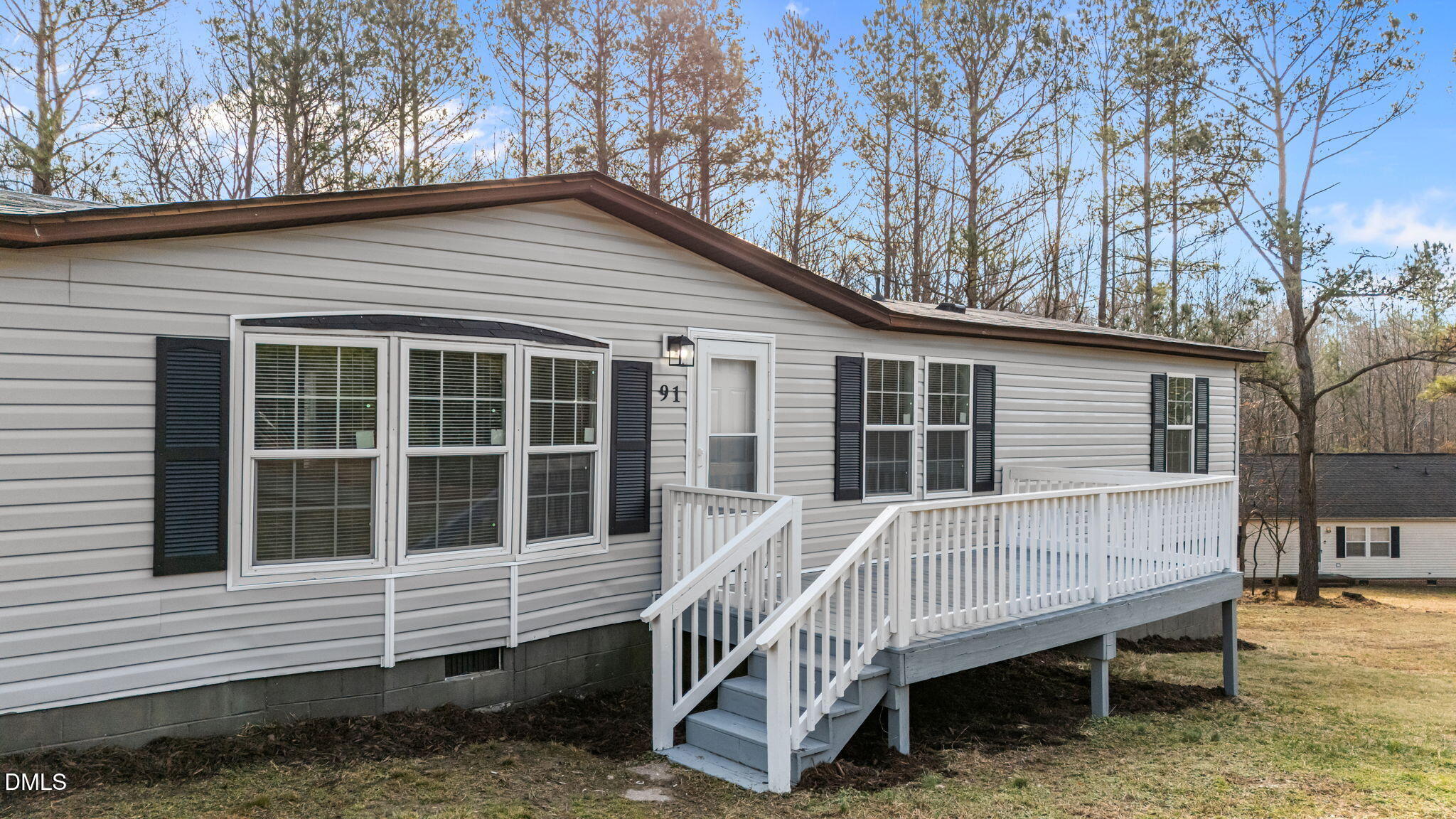 91 Pine Ridge Road Henderson, NC 27537 - Photo 5 of 50 a view of a house with a yard and wooden deck