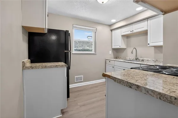 a kitchen with a sink and a stove top oven