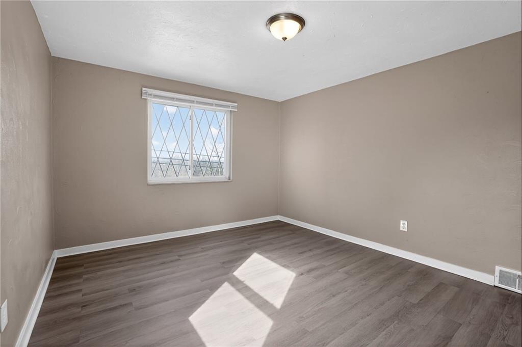 8030 Lincoln Road Verona, PA 15147 - Photo 12 of 34 an empty room with wooden floor and windows