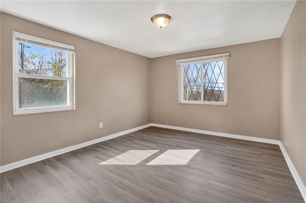 8030 Lincoln Road Verona, PA 15147 - Photo 13 of 34 an empty room with wooden floor and windows