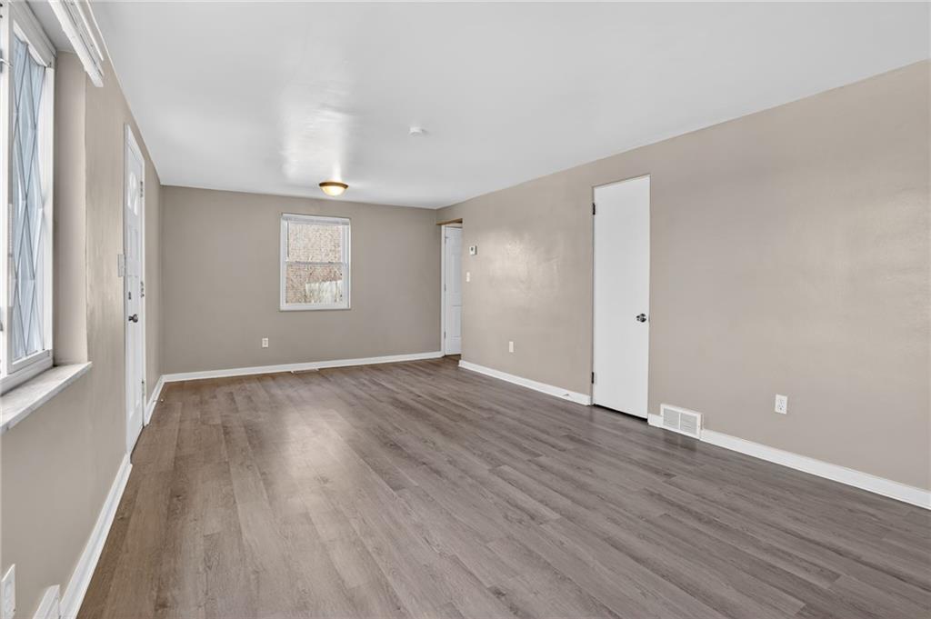 8030 Lincoln Road Verona, PA 15147 - Photo 14 of 34 an empty room with wooden floor and windows