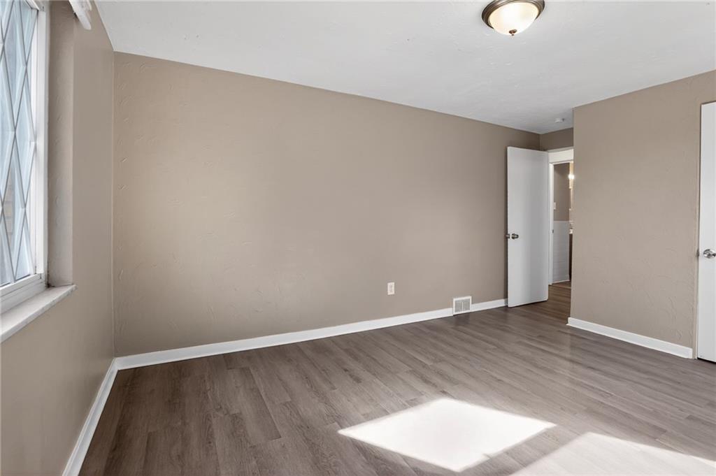 8030 Lincoln Road Verona, PA 15147 - Photo 17 of 34 an empty room with wooden floor and windows