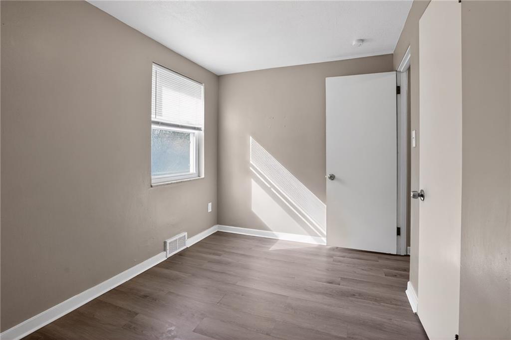 8030 Lincoln Road Verona, PA 15147 - Photo 19 of 34 an empty room with wooden floor and windows