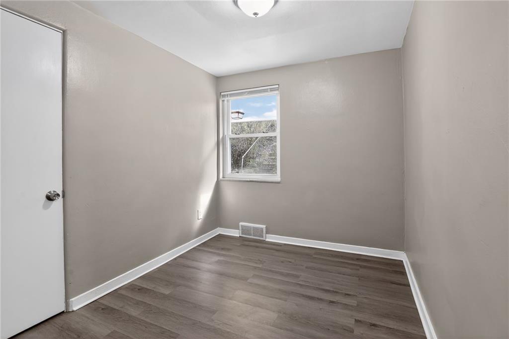 8030 Lincoln Road Verona, PA 15147 - Photo 21 of 34 a view of a small space with wooden floor and a window