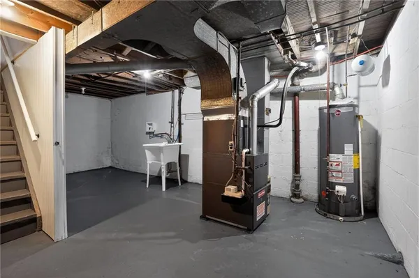 a view of water heater room with stairs